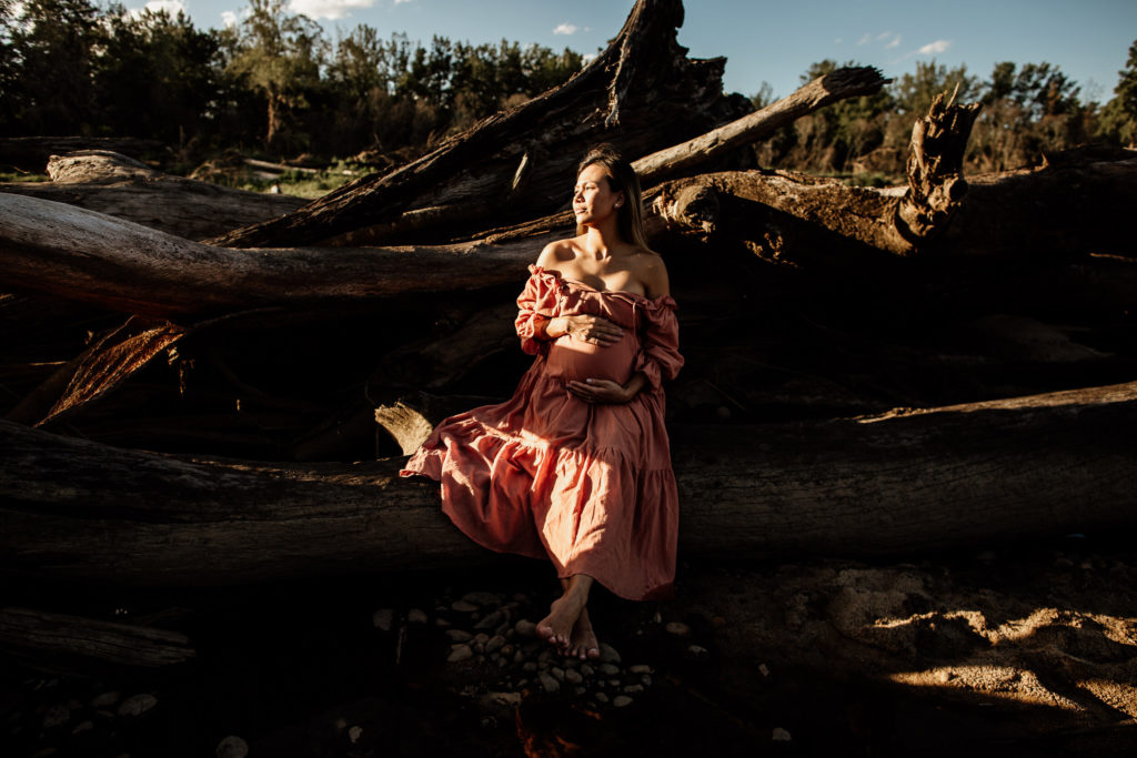 Female Maternity Shoot in a dramatic lighting, outdoors in nature