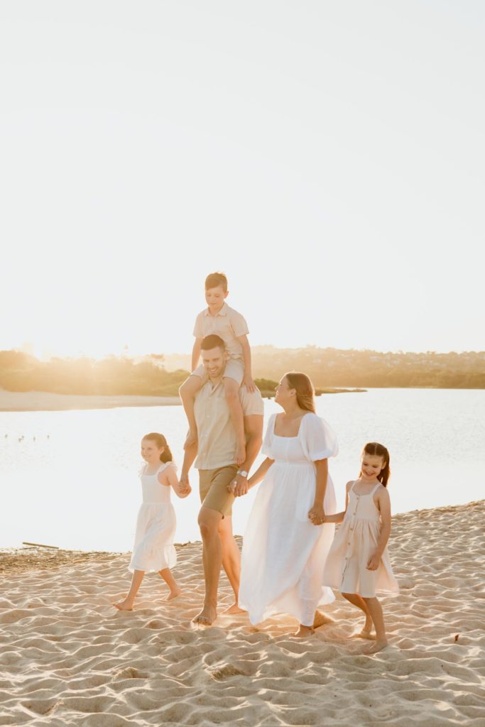 Family of five walking along the beach in Sydney