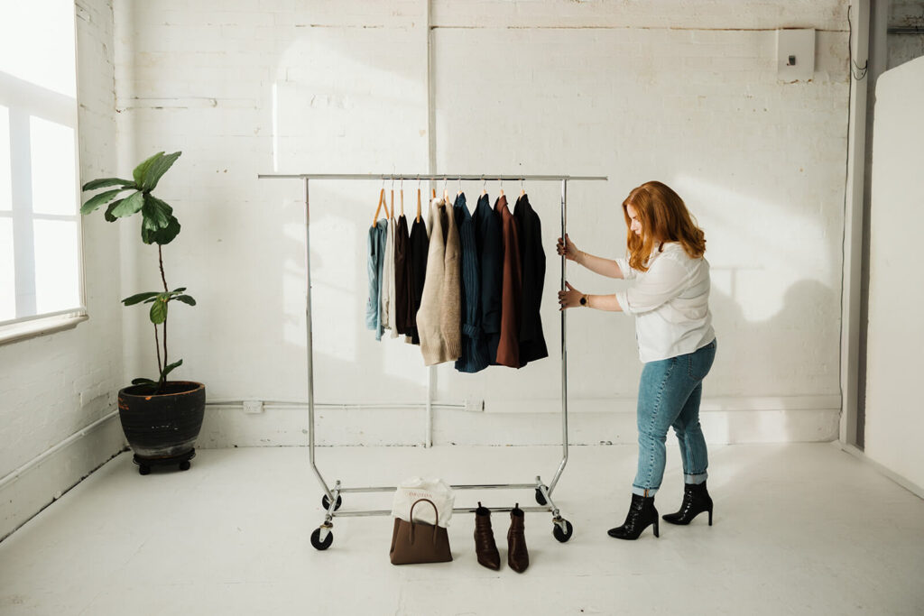 Sydney fashion stylist setting up rack of clothing options for a client