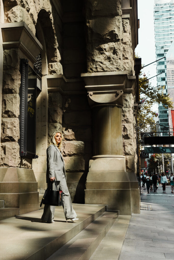 Confident female entrepreneur walking through Sydney city in professional branding photoshoot