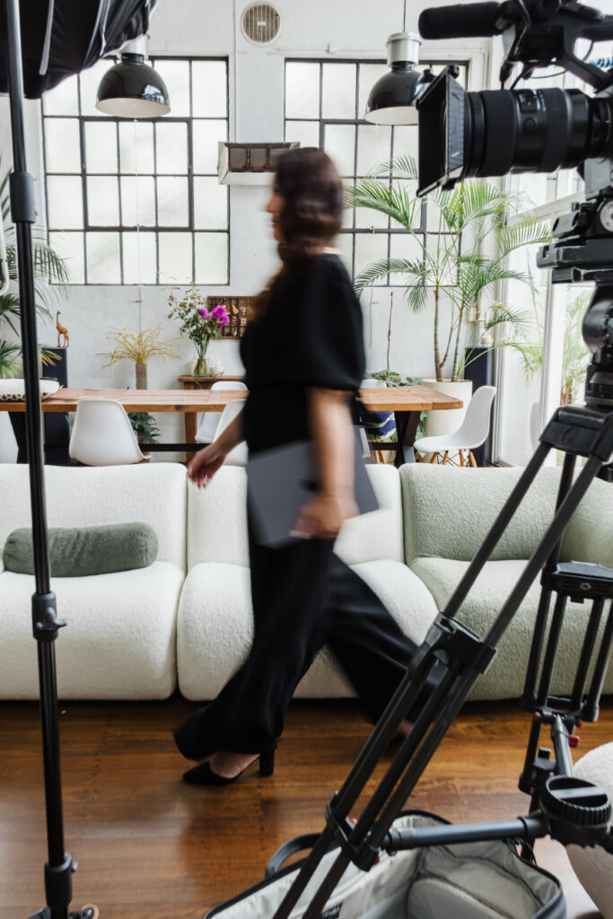 Videographer moving through studio space during business branding photoshoot